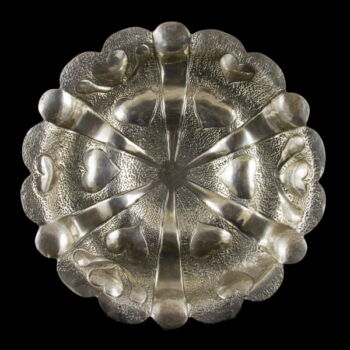 Three-legged silver serving plate with heart pattern