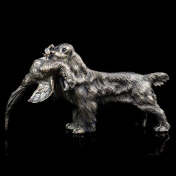 Mini silver hunting dog Spaniel with pheasant