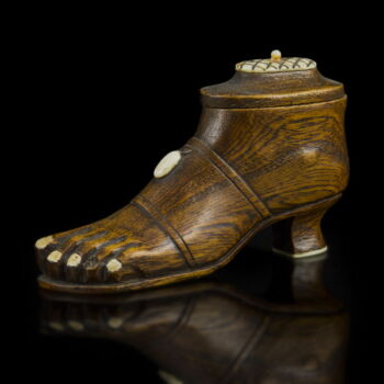 Carved wooden foot with bone inlays and dice